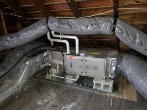 An attic HVAC air handler unit with insulated ductwork installed by Perfect Comfort Systems in San Bernardino, CA