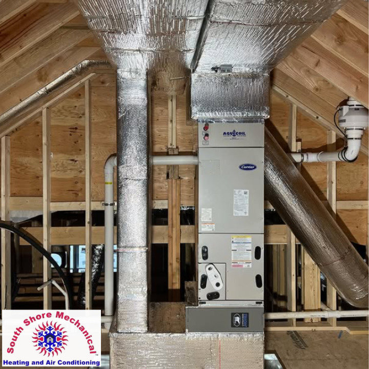 An air handler unit and ductwork installed in an attic space by South Shore Mechanical in Abington, MA