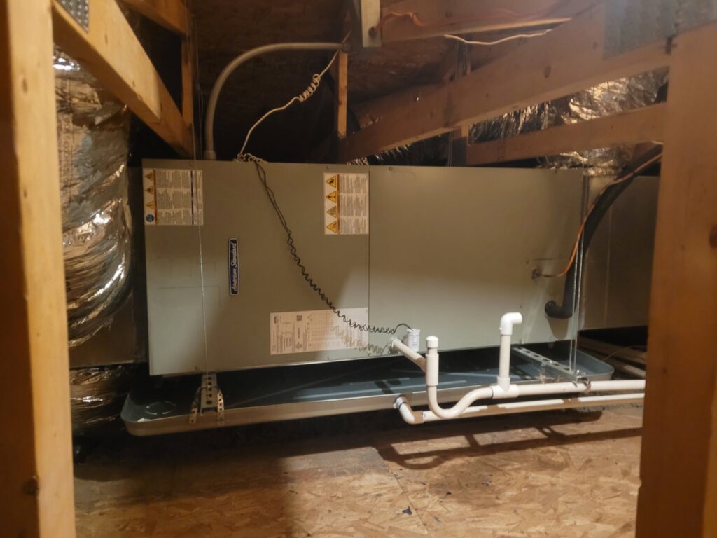 An air handler unit suspended in an attic with a drain pan, installed by Vertex Heating & Cooling in Buckeye, AZ