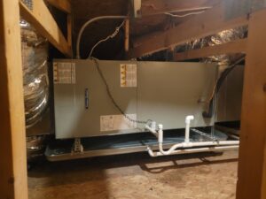 An air handler unit suspended in an attic with a drain pan, installed by Vertex Heating & Cooling in Buckeye, AZ