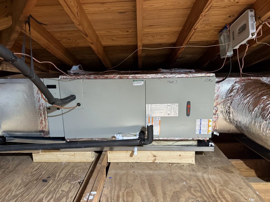 An HVAC air handler unit and ductwork installed in an attic by Willman Air in Jacksonville, FL.