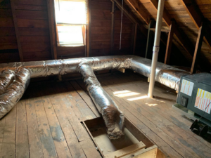 Insulated HVAC ductwork and an air handler unit installed in an attic by After Hours Home Services in Hampton, VA.