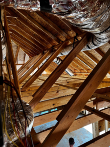 HVAC ductwork being installed in an attic space by Diversified Services NA in Rogers, AR.