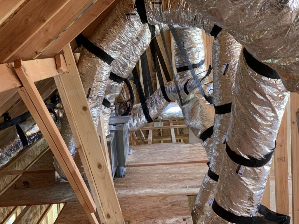 Flexible insulated HVAC ductwork installed in an attic space during new construction by Trinity Climate Control in Goldsby, OK.