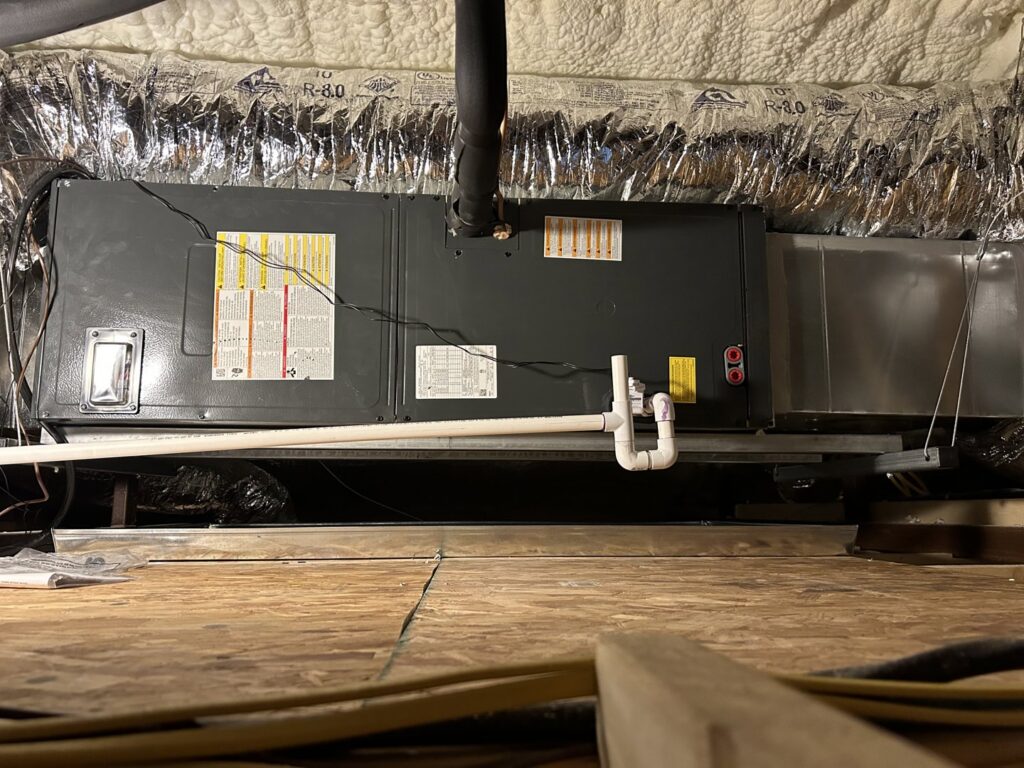 An indoor air handler unit with ductwork installed in an attic space by Oklahoma Climate Solutions in Oklahoma City, OK.