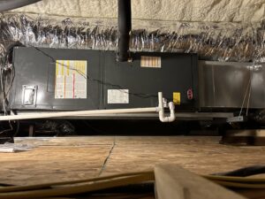 An indoor air handler unit with ductwork installed in an attic space by Oklahoma Climate Solutions in Oklahoma City, OK.