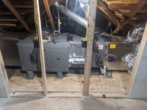 An HVAC system with furnace and ductwork installed in an attic by Totality Heating And Cooling in Edmond, OK.