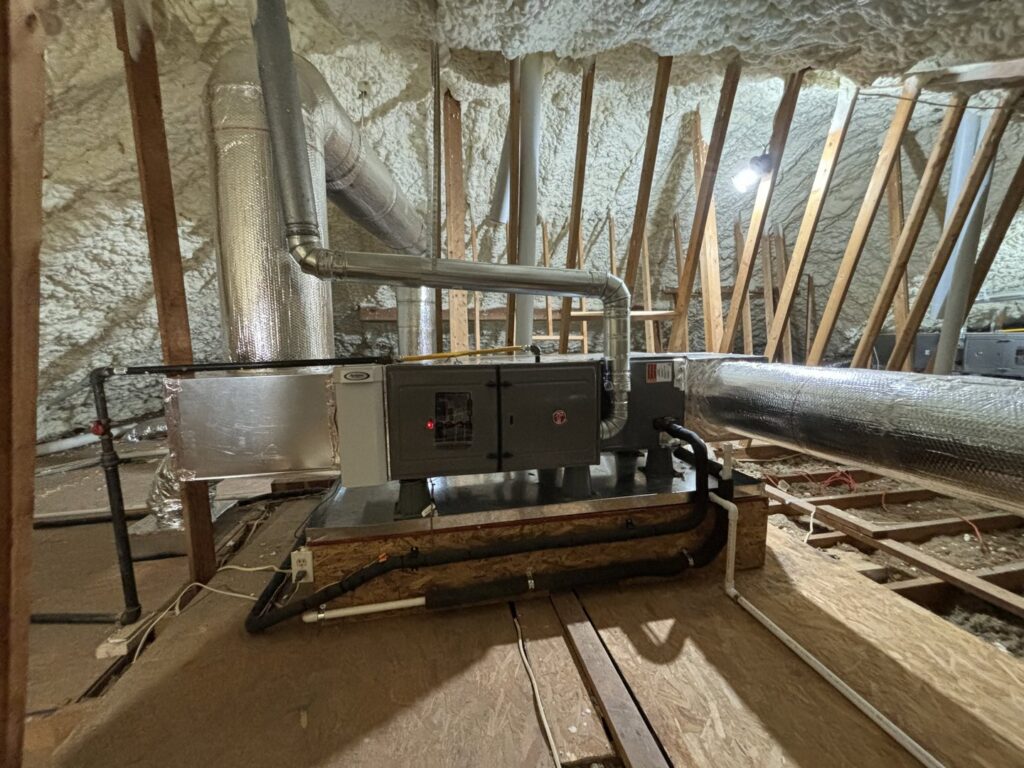 Attic HVAC system with air handler and ductwork surrounded by insulation by ACE Heating & Cooling, Inc. in Jonesboro, AR