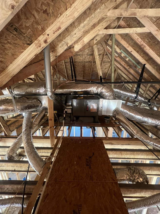 An HVAC unit and ductwork installation in an attic by Call The Doc Air Doctor Heating, Air Conditioning and Plumbing in Richardson, TX.