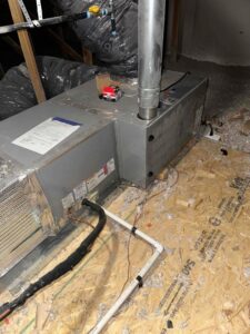 An HVAC air handler or furnace unit installed in an attic or crawl space by Authority Heating & Cooling in Orem, UT.