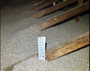 Attic insulation depth being measured after installation by Assured Energy Solutions in Frankfort, IL.