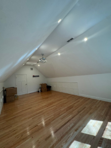 Attic room showcasing new recessed lights and a decorative ceiling fan chandelier installed by P. Cruz Electric LLC in Springfield, MA.