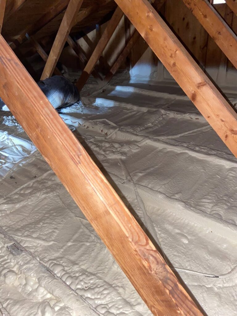 Attic with new spray foam insulation, an energy efficiency service by Service Legends in Des Moines, IA.