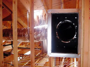 An attic space with wooden framing and a large metal vent, showing an area for wildlife exclusion by Myzzer in Bellevue, WA.