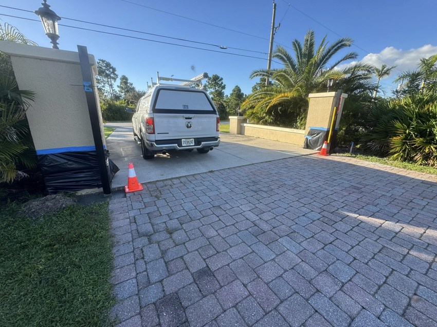 Installation of an automatic gate post at a residential driveway by Big Bear Automatic Gates, LLC in La Belle, FL.