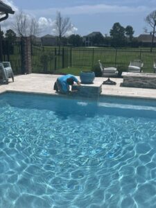 An automatic pool cleaner operating in a clean swimming pool, provided by Gayle Force Pools in Lake Charles, LA