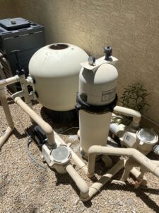 An automatic pool cleaner actively cleaning the bottom of a residential pool for BEHR POOLS Service & Repairs in Glendale, AZ