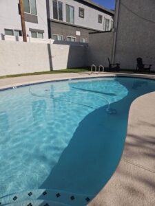 An automatic pool cleaner working in a clean urban pool by Vanguard Pool Care in Phoenix, AZ