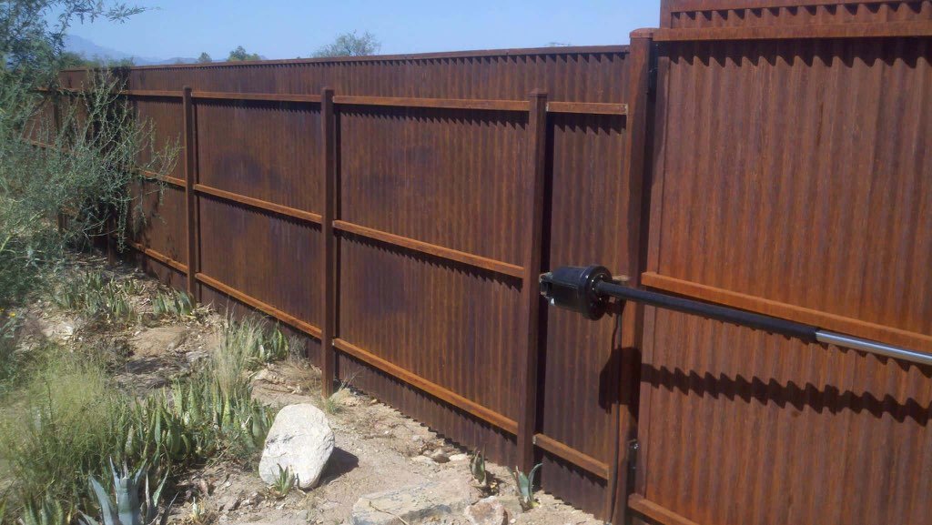An automatic rustic corrugated metal gate and fence installed by Fence Company Tucson in Tucson, AZ.