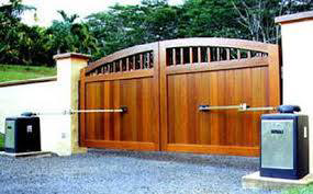A beautiful automatic wooden driveway gate installed by Royal Garage Door Services in Boston, MA