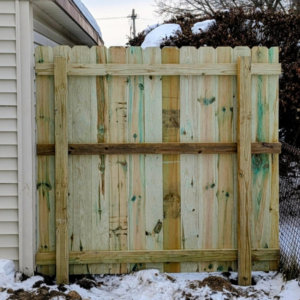 The back view of a newly installed wood fence showing posts and supports by Mjölnir Design in Milwaukee, WI.