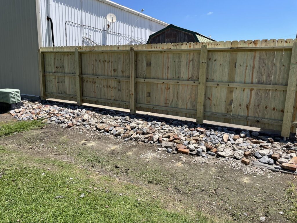 The sturdy backside of a newly installed wood privacy fence, built by 985 Fence, LLC in Schriever, LA.
