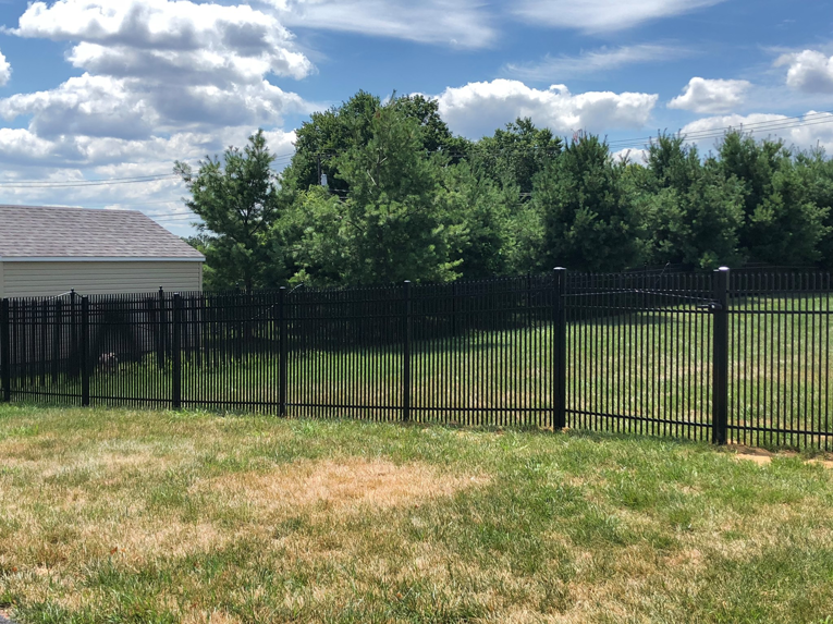 A black aluminum fence enclosing a backyard area, installed by Mercer Fence Company in Hamilton Township, NJ.