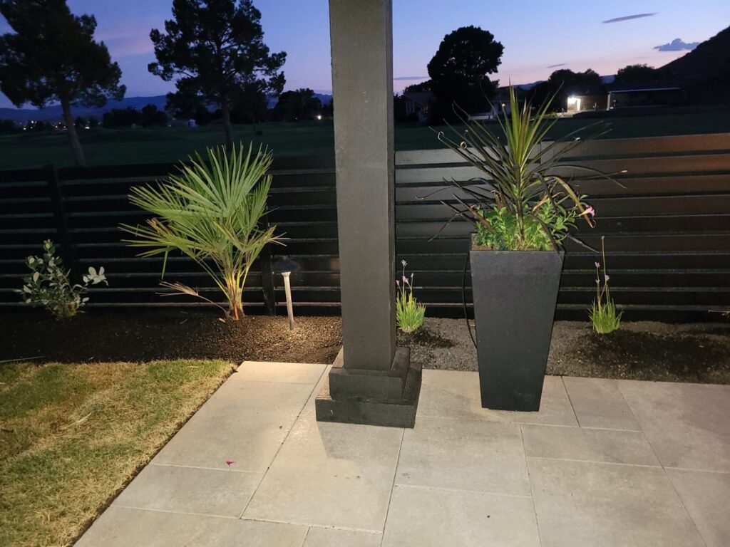 A modern black horizontal slat fence enclosing a landscaped backyard by Allied Fence Co in Tulsa, OK.