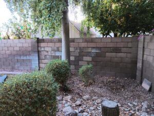 A sturdy block wall serving as a backyard fence installed by Arce Masonry LLC in Glendale, AZ