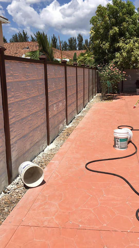 A newly installed concrete privacy fence in a backyard by Miami Concrete Fence in Miami, FL
