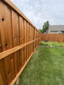 A natural wood privacy fence viewed from inside a backyard, showcasing work by ZBros Fencing LLC in Boise, ID.