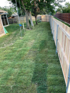 A long view of a backyard with a newly installed wood privacy fence by DWM FENCE in Norman, OK