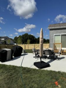 A new wood fence enclosing a backyard patio area with outdoor furniture, installed by ReliableFencing in Columbus, OH.
