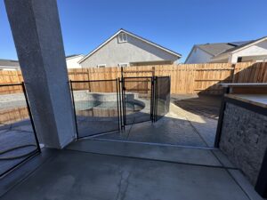 A backyard pool barrier with a self-closing gate, expertly installed by Golden State Baby Barrier in Sacramento, CA.