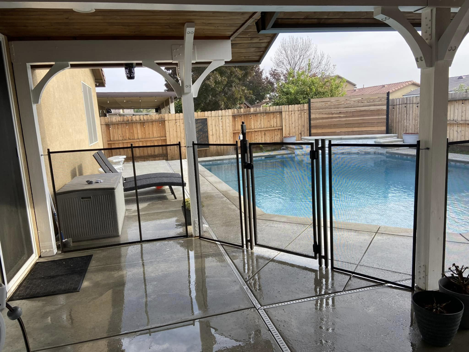 A secure backyard pool safety fence with a gate, expertly installed by A Safe Pool Enclosures in Bakersfield, CA.