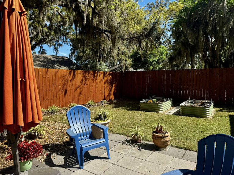 A residential backyard featuring a newly installed wooden privacy fence by Barwick Fence Company in Savannah, GA.