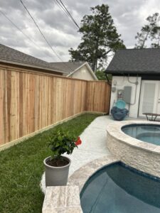 A newly installed wood fence defining a backyard and pool area by Wood Fence Houston in Houston, TX.