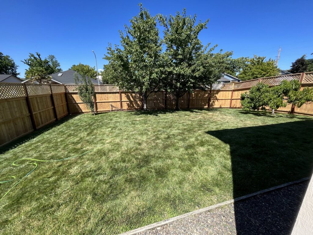 A complete backyard wood fence enclosure with lattice top installed by Prestige Fencing LLC in Medford, OR.