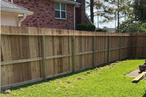 A completed wooden fence installation in a residential backyard by Alexi's Handyman Services in Indianapolis, IN.