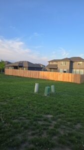 A newly installed wood fence in a residential backyard by Fencing Company Of Omaha in Omaha, NE.