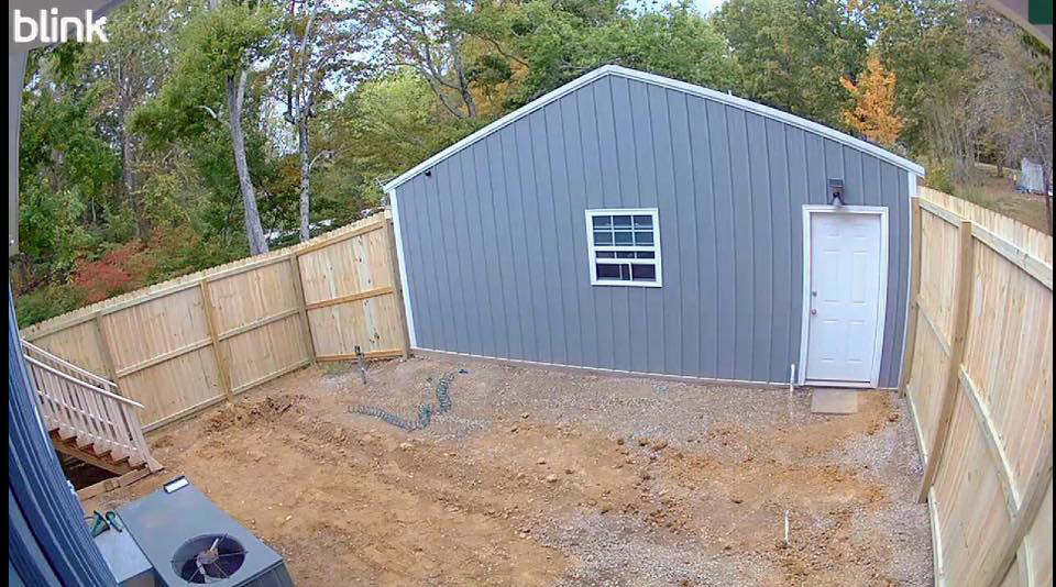A backyard with new wood fence installation by Higdon's fence install & repair in White Mills Junction, KY