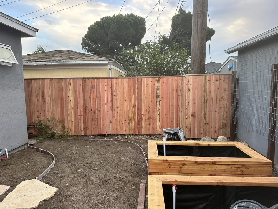 A newly installed wood fence in a backyard with raised garden beds by Don Peterson Wood Fences & Decks in Santa Monica, CA.