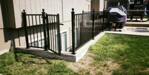 A backyard wood picket fence viewed from a deck, installed by Royal Fence & Design LLC in Olathe, KS.