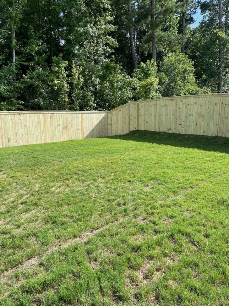 A new wood privacy fence installation in a backyard by 3A Fencing & Landscaping in Atlanta, GA.
