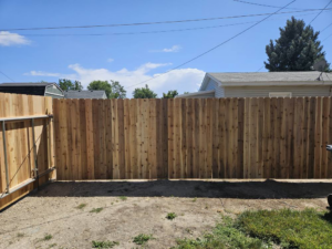 A completed backyard wood privacy fence installation, showcasing quality craftsmanship by Regan Fencing & Services in Nampa, ID.