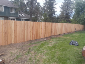 A newly installed wooden privacy fence in a residential backyard by The Best Fence Company in Spokane, WA.