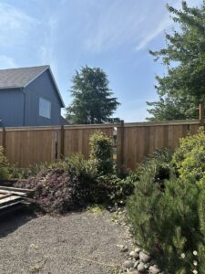 A tall, newly installed wood privacy fence defining a backyard boundary by RPB Fence in Salem, OR
