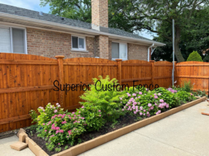 A beautiful new wood privacy fence installed in a residential backyard by Superior Custom Fence Inc. in Chicago, IL.