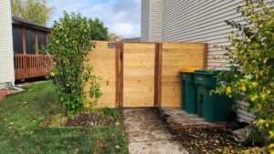 Backyard wood privacy fence installed among trees by All Terrain Fence LLC in Waukegan, IL