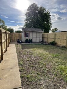 A wooden privacy fence enclosing a residential backyard with a shed, installed by DZS Fencing, LLC in Red Lion, PA.